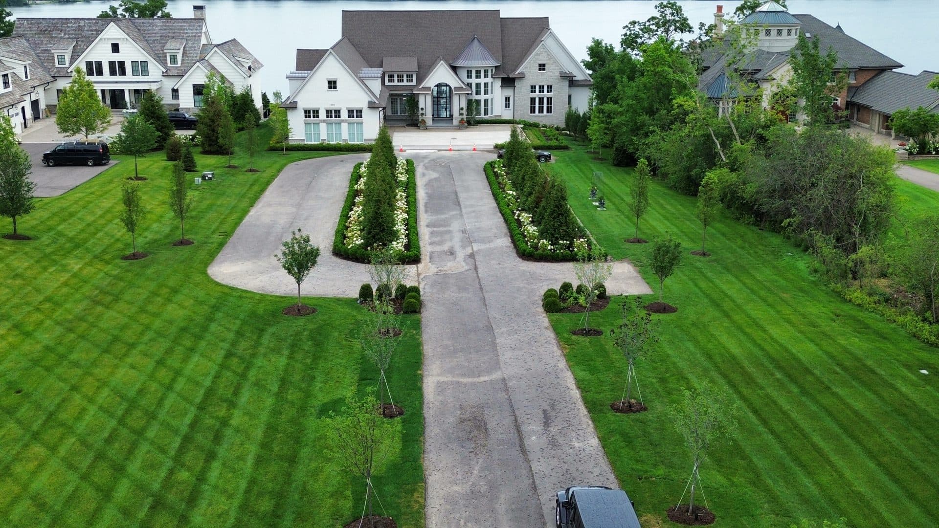 Aerial of a lush striped estate lawn with mature plantings in Bloomfield